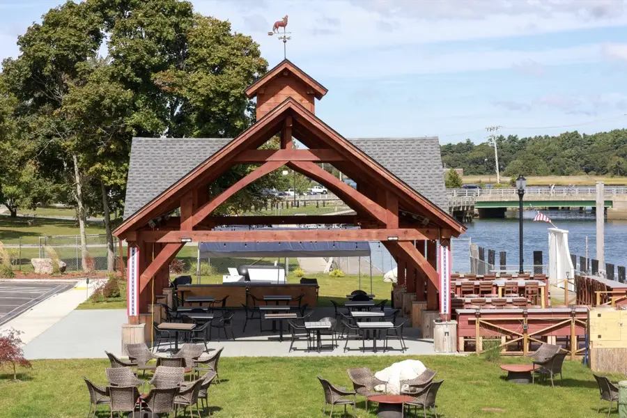 Outdoor pavilion and lawn overlooking the harbor
